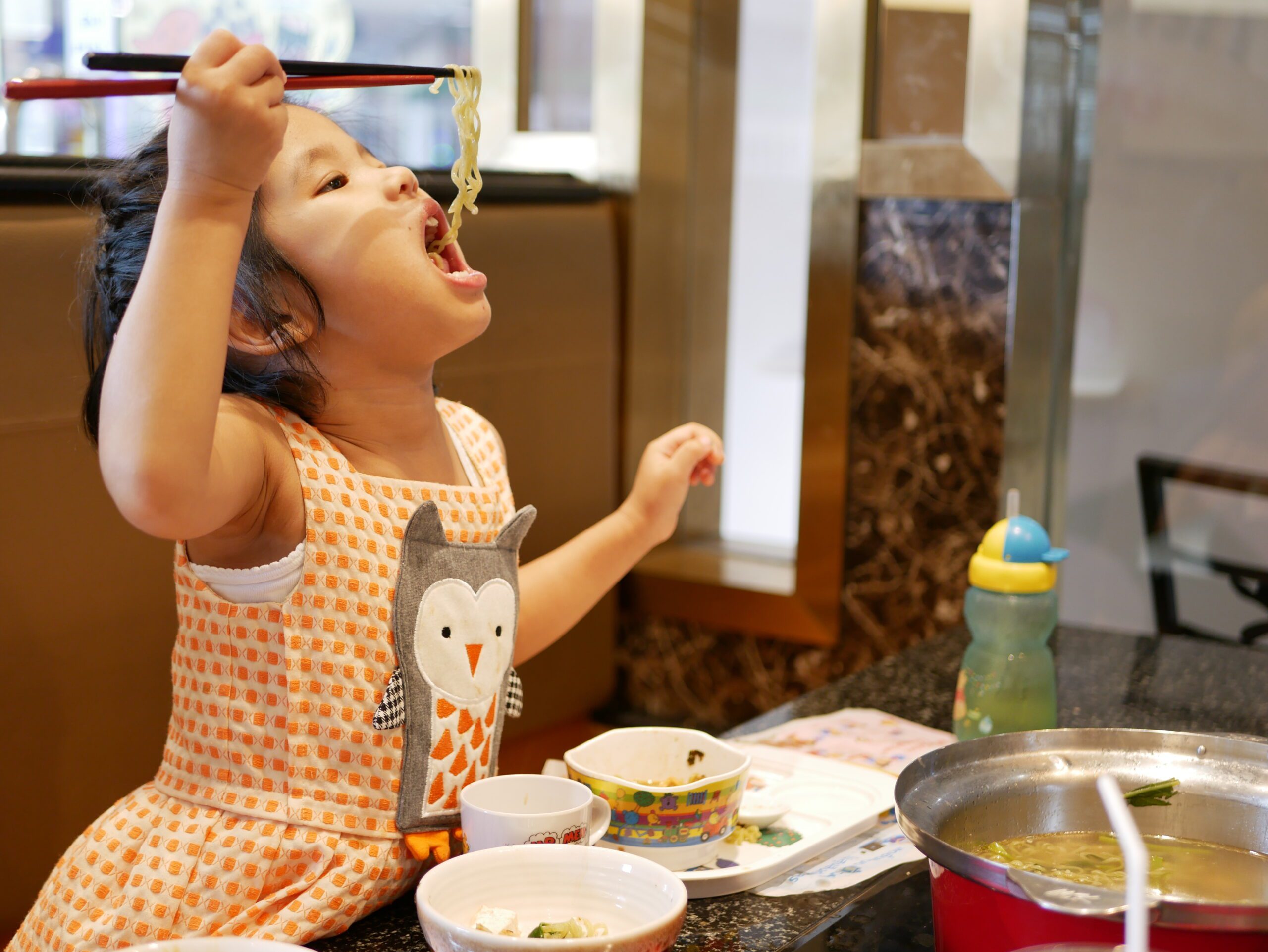 Little baby girl, 4 years old, holding chopsticks learning to us Intensive Tube Weaning Programme, Paediatric Feeding/ARFID Therapy Clinic